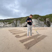 Elliott designing beach art for a national marketing campaign.