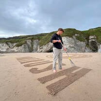 Elliott designing beach art for a national marketing campaign.