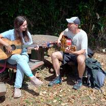 Intern playing guitar with our music teacher