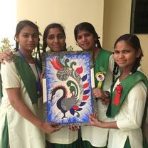 Students holding an artwork