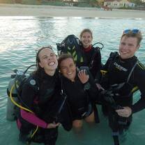 Divers pose in a pool