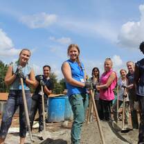 Learning how to mix concrete by hand.