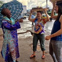 students laughing with a woman on the street