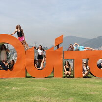 Students hanging around on the Quito sign