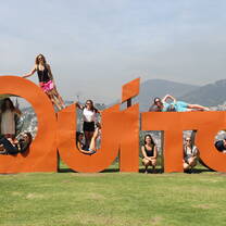Students hanging around on the Quito sign