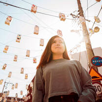 Student amidst street decorations