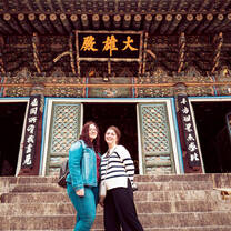 Two students in front of a building in South Korea