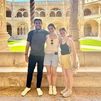 Three students pose in front of historical building in Portugal