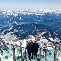 Three students in front of beautiful mountainscape in Austria