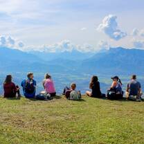 Students with their back towards the camera facing beautiful mountains