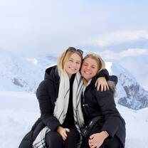 Two students posing in front of chilly mountains