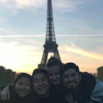4 participants gather close for a photo in front of the Eiffel Tower