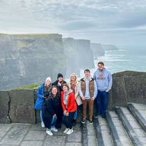 Participants gather in front of a beautiful view