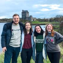 Participants pose in front of beautiful Irish landscape