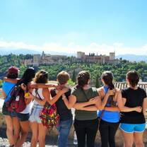 Participants put their arms around each other and pose for a photo