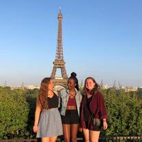 3 participants posing with the Eiffel Tower in the background