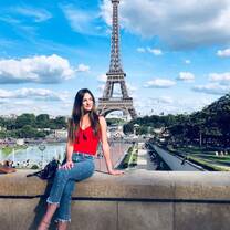 Student poses with the Eiffel Tower in the background