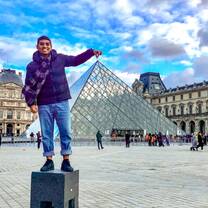 Participant poses outside of the Louvre in France