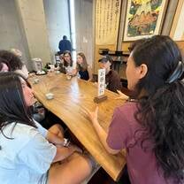 group talking at a wooden table
