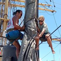 Two sailors Aloft putting sails away