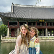 Two female students in front of a temple