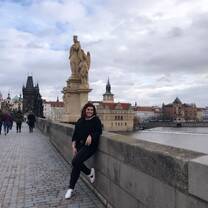 Student poses for picture overlooking beautiful architecture in Prague