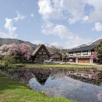 japanese style house with pink cherry blossoms