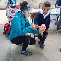 Volunteer teaching the correct brushing techniques
