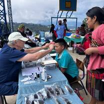Volunteer delivering glasses