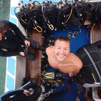 a diver looks up at the camera, smiling 