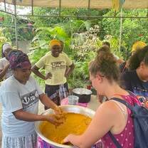 CET Brazil students and locals in Salvador da Bahia cooking together in a large pot