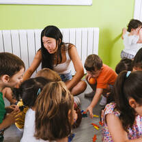 A female LITA student in her internship, working with young children 
