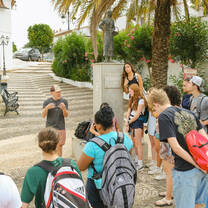 LITA students standing in a group and speaking with a community partner and LITA Director Jordan Romm