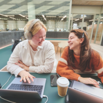 Two studens using the study spaces at Elm House 