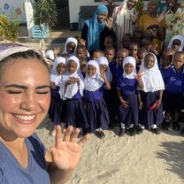 Volunteer Rayana with the staff and children