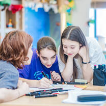 Campers learning together at classroom