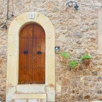A beautifully rustic stone doorway with wooden details in Spain, a perfect glimpse into Spanish history for RVF participants.