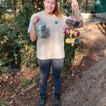 Volunteer showing an enrichment device made for animals