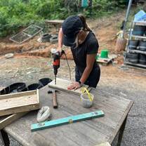 Volunteer building a feeding platform