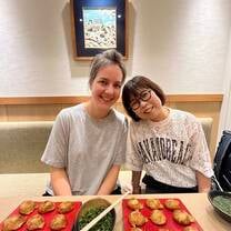 Student enjoying Akashi-yaki, the origin of takoyaki