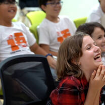 A camper laugh happily at the graduation ceremony