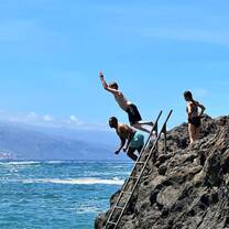 People jumping off a cliff