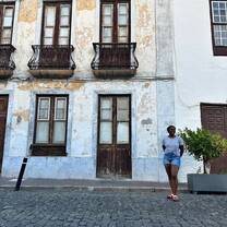 Woman posing in front of building