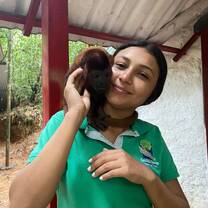 Volunteer holding a monkey around her neck