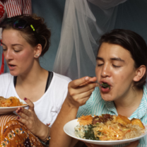 Volunteers eating local dishes