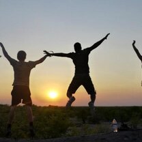 Students jumping facing the sunset