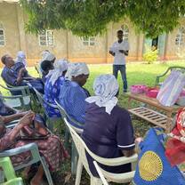 man providing education to group of Kenyan women