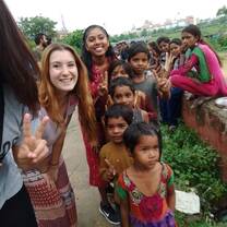 Volunteers from Italy and UK playing with children while participating in a childcare program in Jaipur while participating in our Volunteer & Travel Program where they cover 10+ cities across India while participating in action-orientated impactful volunteering activities along with cultural immersion through travel to historic monuments, participating in art & food related workshops and much more