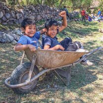 VISIONS Peru kids in wheelbarrel 