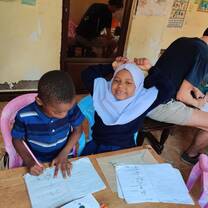 International volunteer engaging in interactive activities with local students